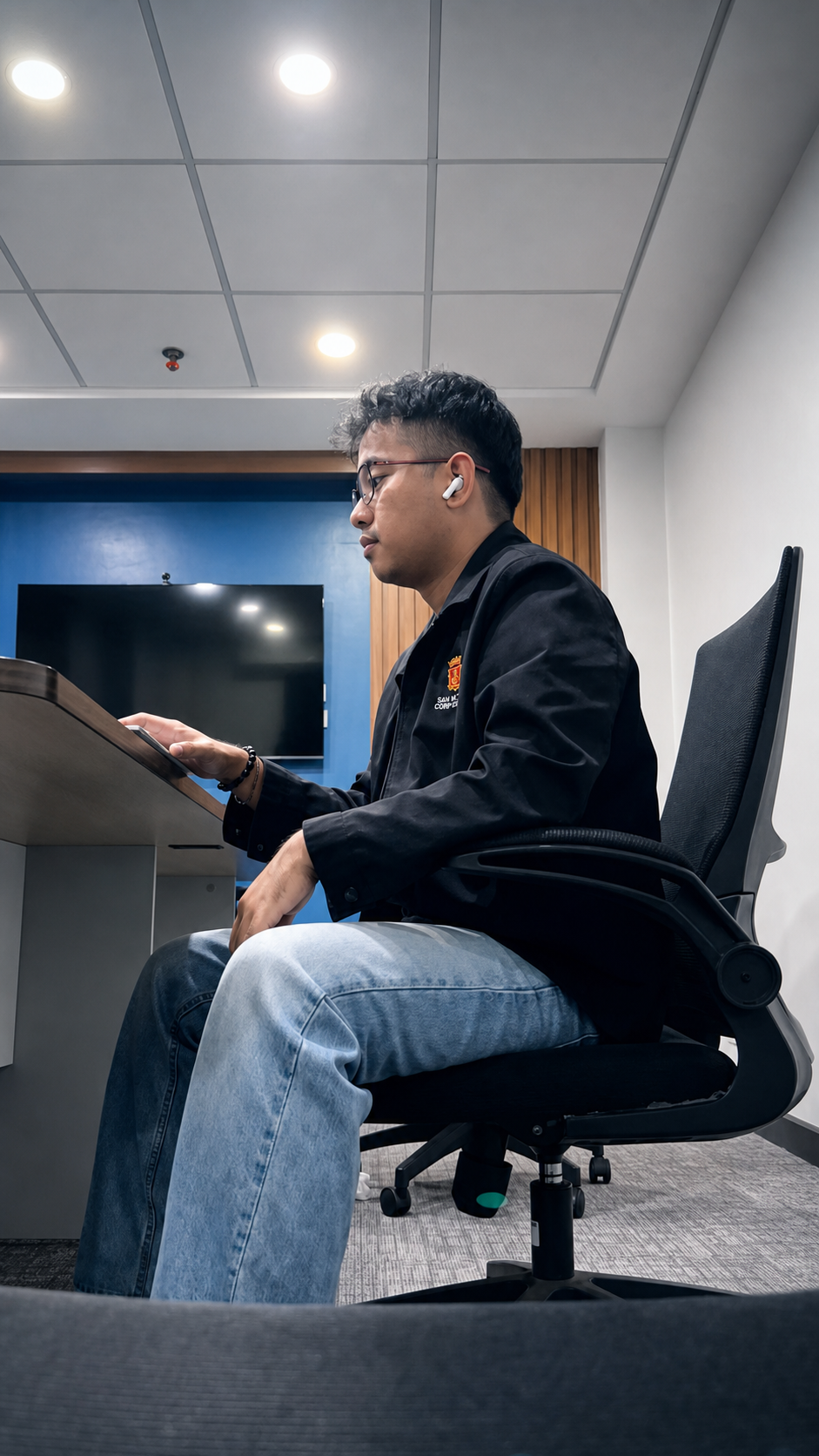 Jhonmar Tolentino working at his desk in a professional office